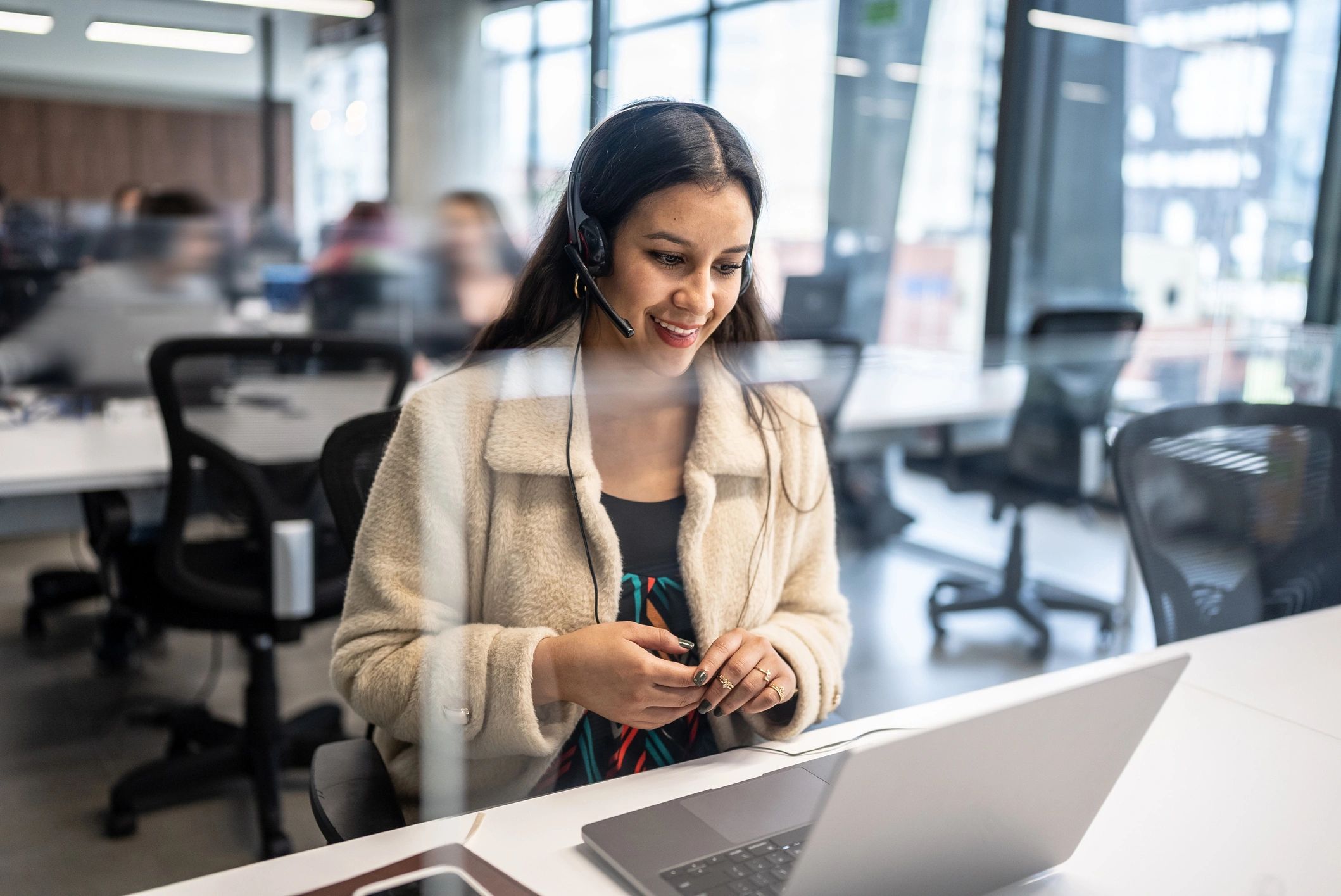 Customer support agent wearing a headset in an office