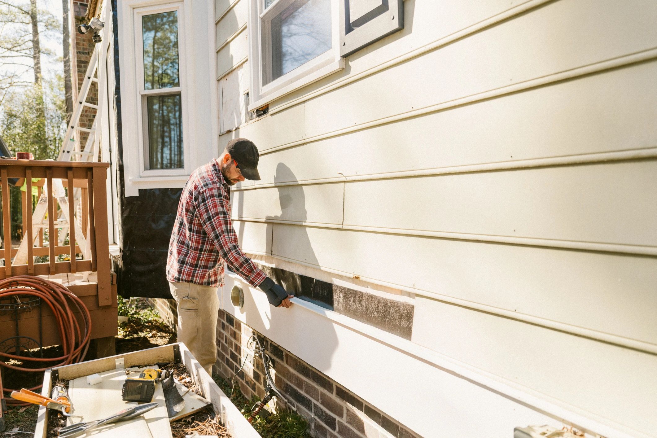 Technician inspecting a home exterior