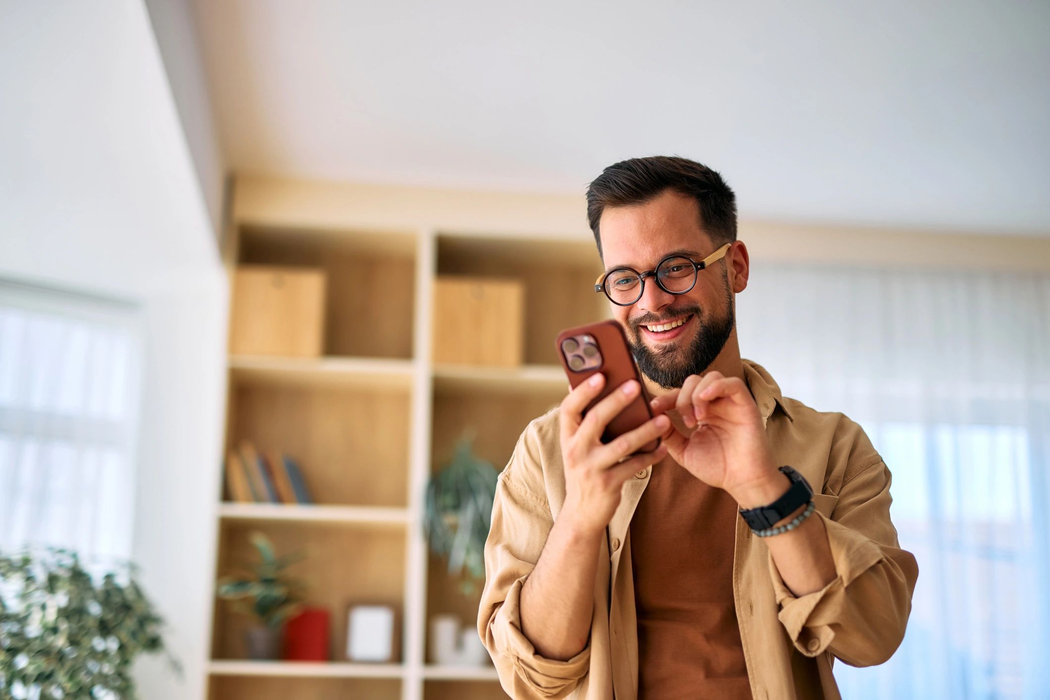 Homeowner using a smartphone to request pest control help